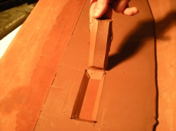 Beveled opening in clay slab